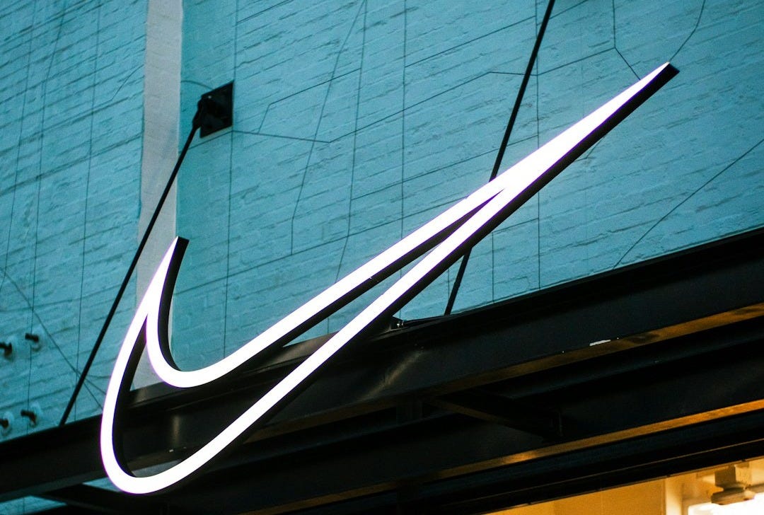 a building with a neon nike sign on the side of it