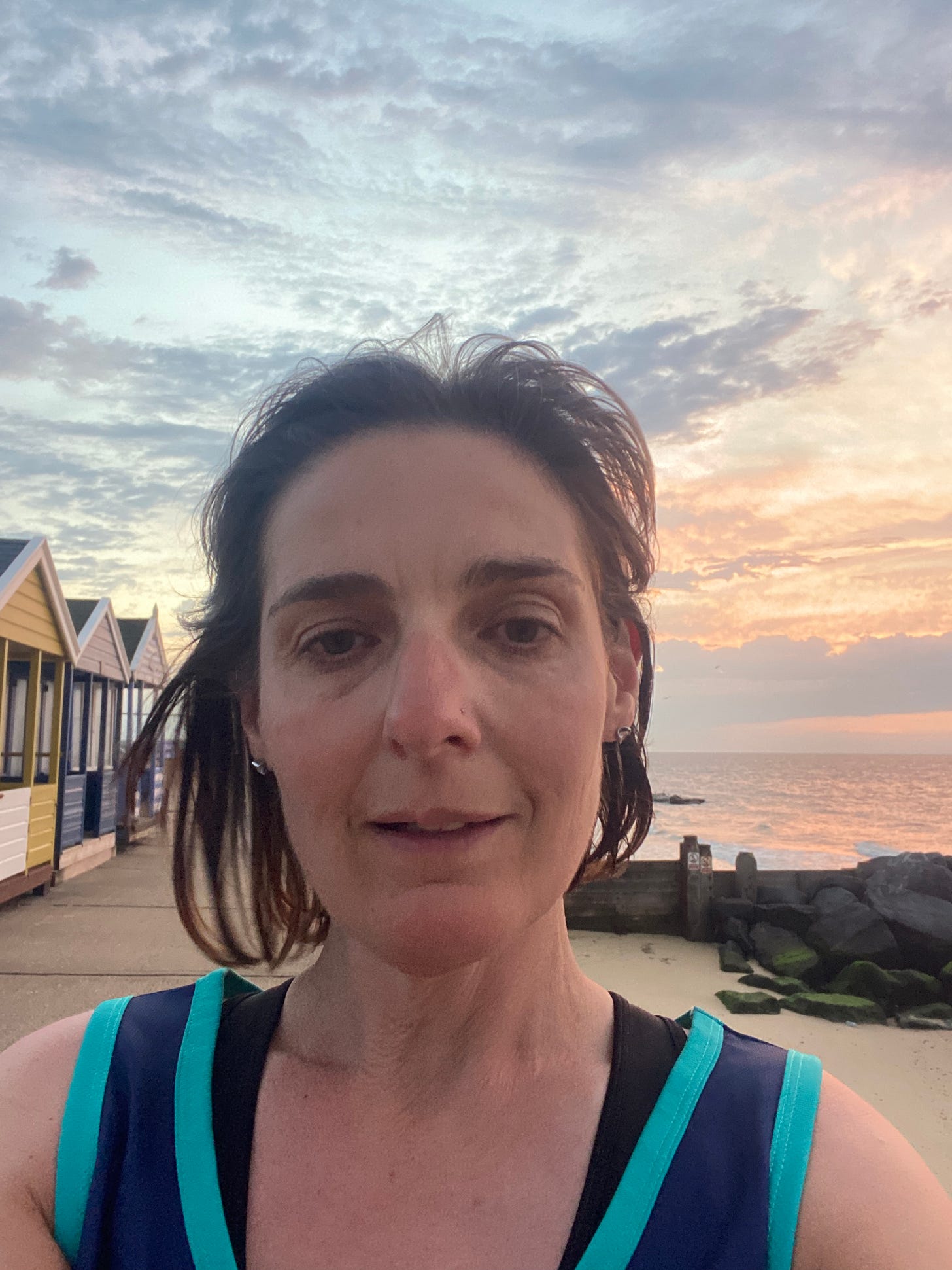 female runner on the beach at sunrise