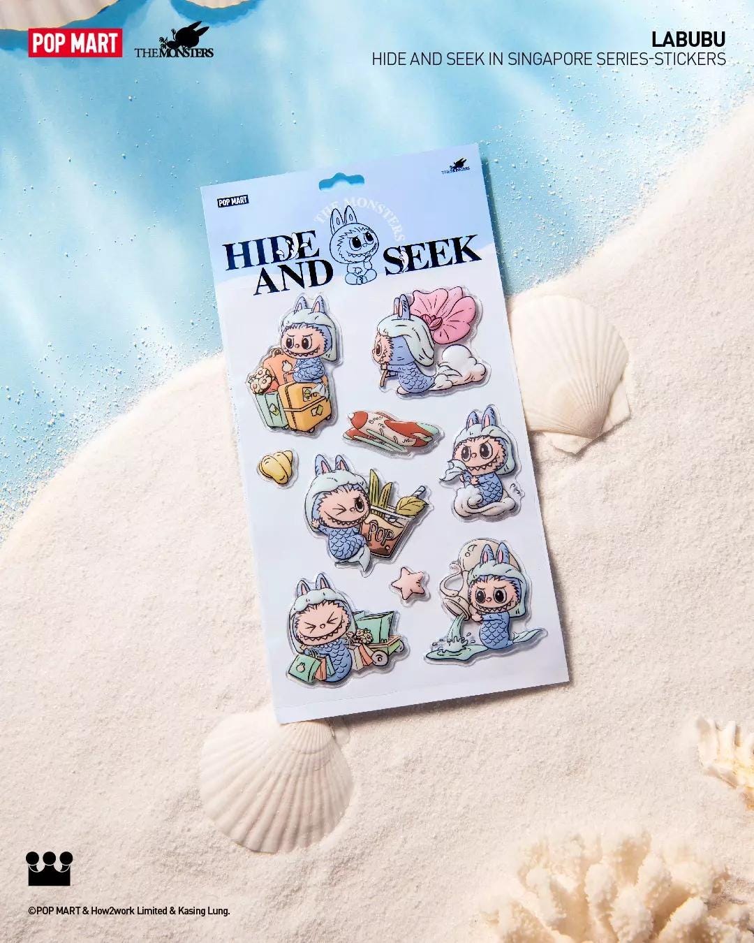 Subject: Labubu Hide and Seek in Singapore sticker sheet resting on sand beside seashells.