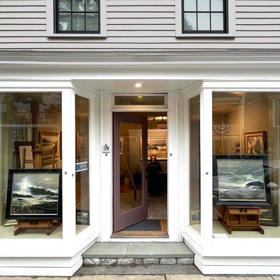 A store front with art in the windows

Description automatically generated