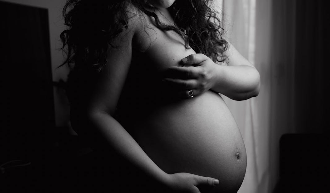 topless woman in grayscale photography