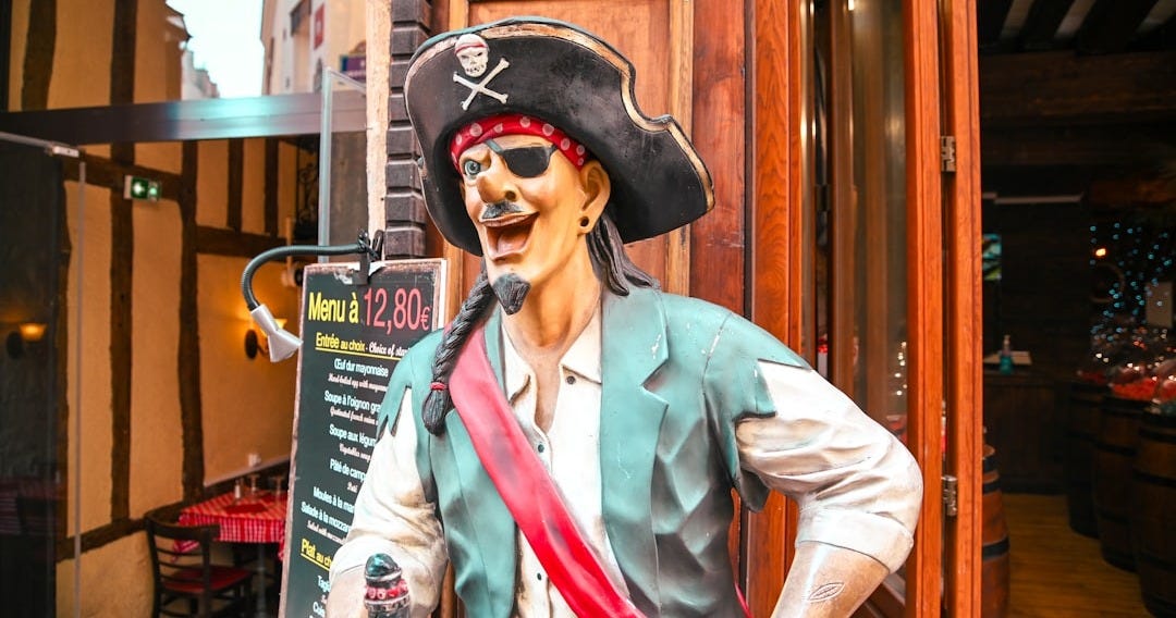 a statue of a pirate holding a bottle of booze