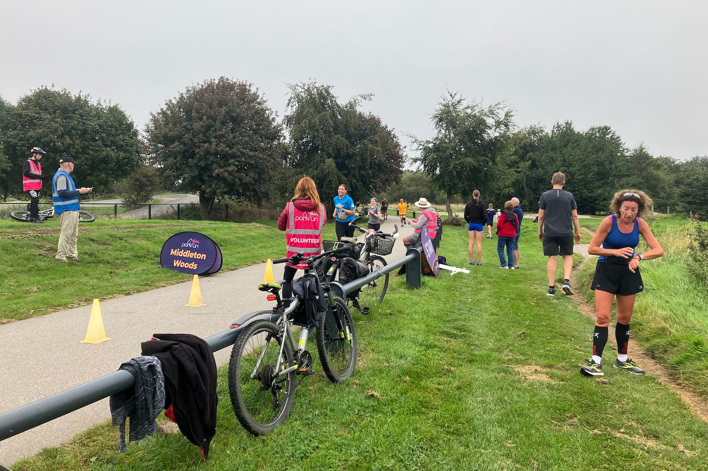 Finish area next to a low barrier with bicycles chained to it