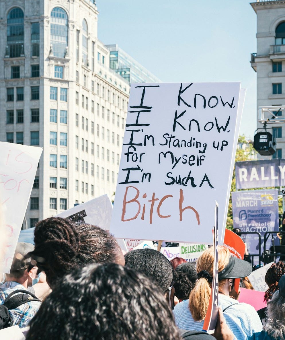 a group of people holding signs in the street