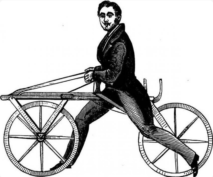 A person riding on the back of a bicycle

Description automatically generated