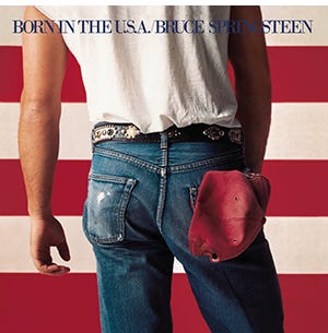 A person in jeans with a hat in his pocket

Description automatically generated