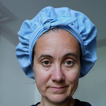women wearing a handmade bonnet in blue cotton with satin lining women wearing a handmade bonnet in blue cotton with satin lining