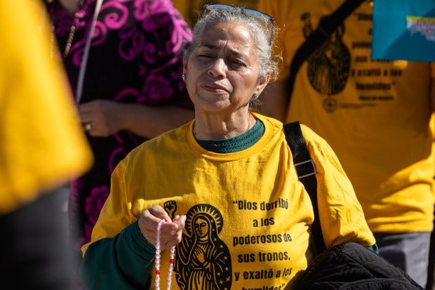 Angela Cervantes of Chicago recites the rosary during a procession...