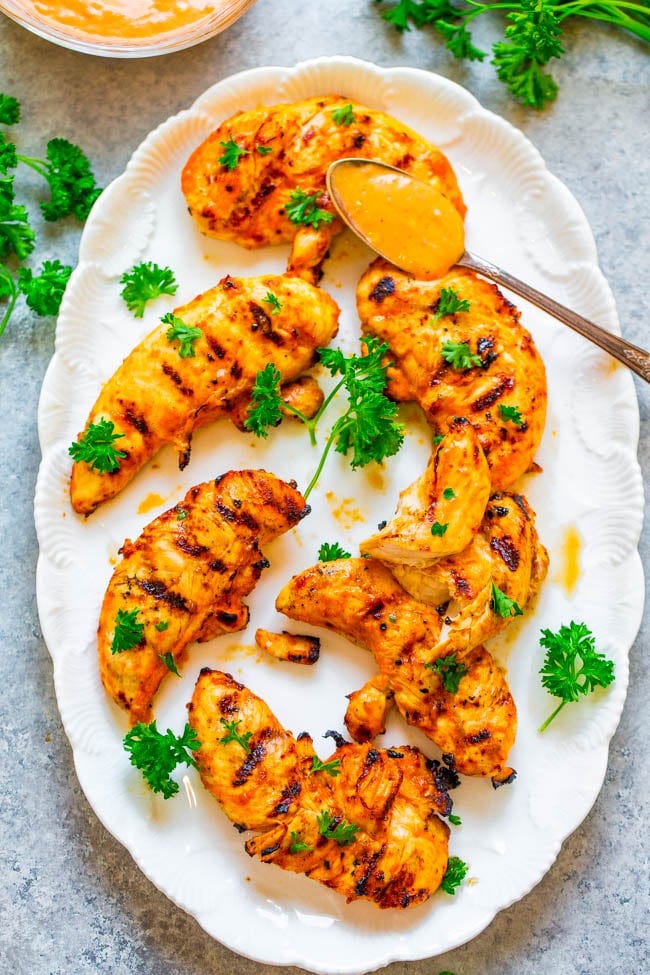 Grilled Spicy Garlic Chicken on a platter with a spoonful of chili garlic marinade. Grilled Spicy Garlic Chicken on a platter with a spoonful of chili garlic marinade.