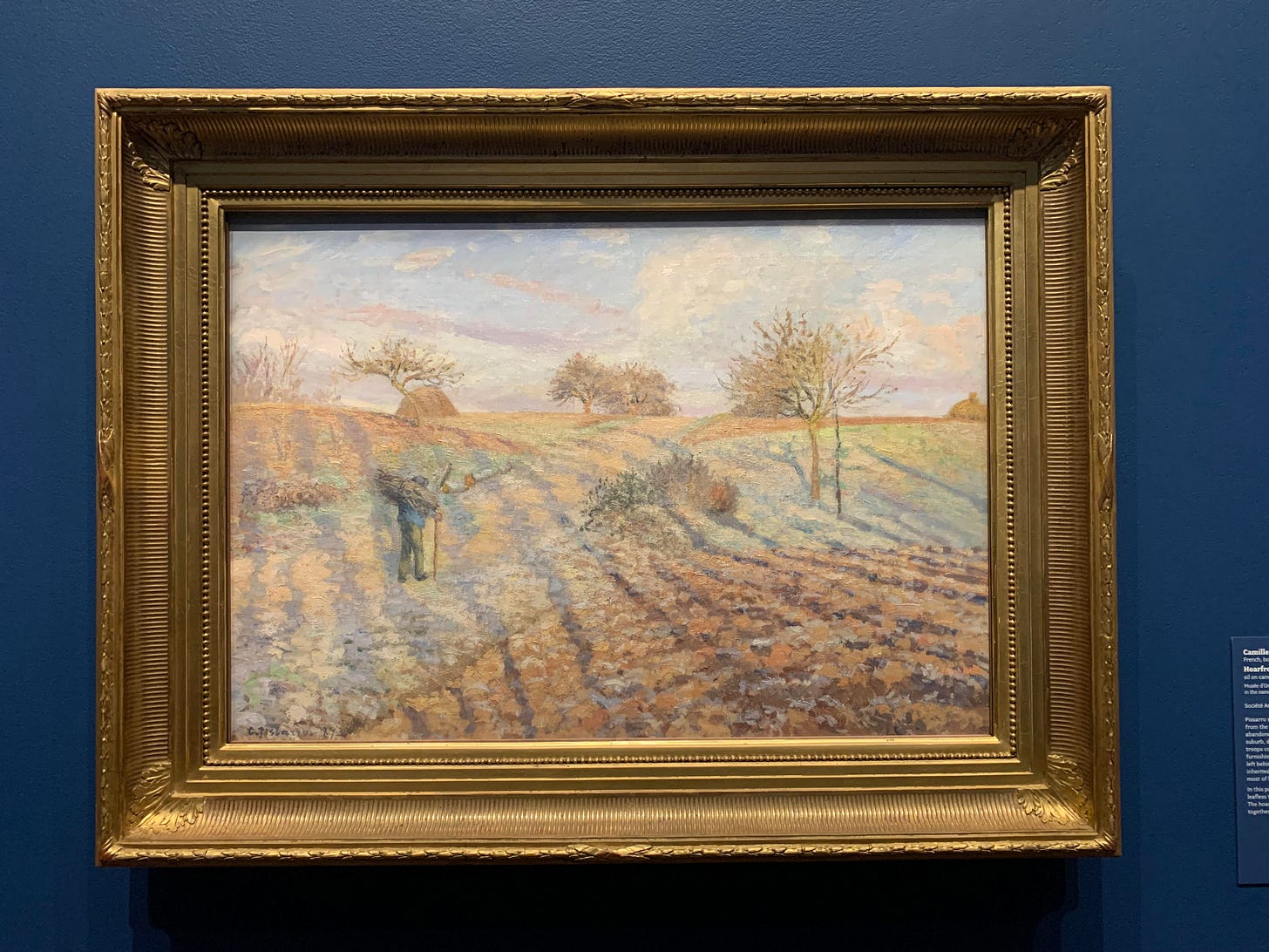 Hoarfrost by Camille Pissarro. There's a figure walking in a field that looks soo damn cold.