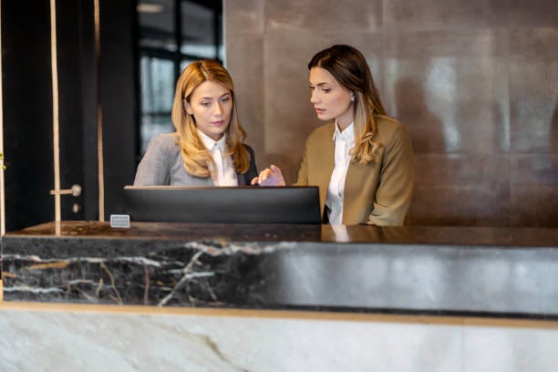 Hotel Manager Talking to Female Receptionists