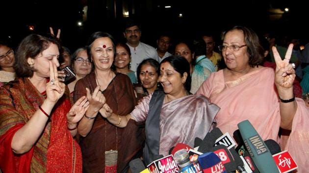 Political leaders Sushma Swaraj, Najma Heptullah, CPI (M) leader Brinda Karat show a victory sign as they celebrate passing of the Women's Reservation Bill in Rajya Sabha, New Delhi. (PTI File Photo)