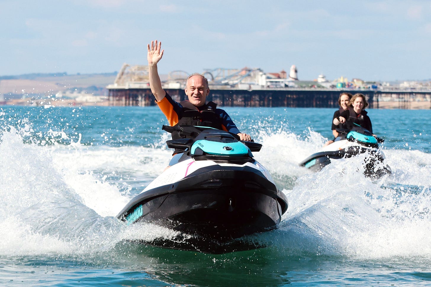 Ed Davey arriving to the Liberal Democrat conference on a jets- Ed waves to the crowd with the Brighton Pier in the background. Ed Davey arriving to the Liberal Democrat conference on a jets- Ed waves to the crowd with the Brighton Pier in the background.