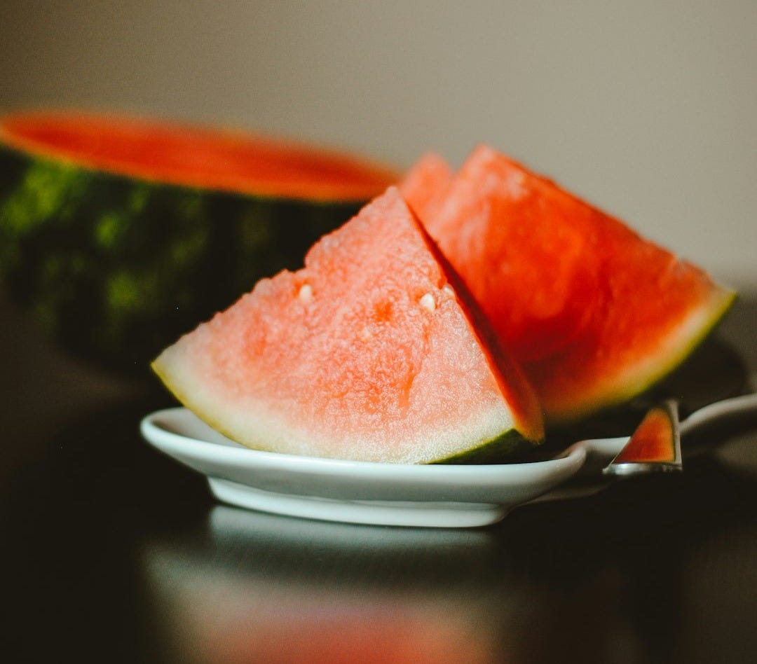 watermelon slice on white ceramic plate