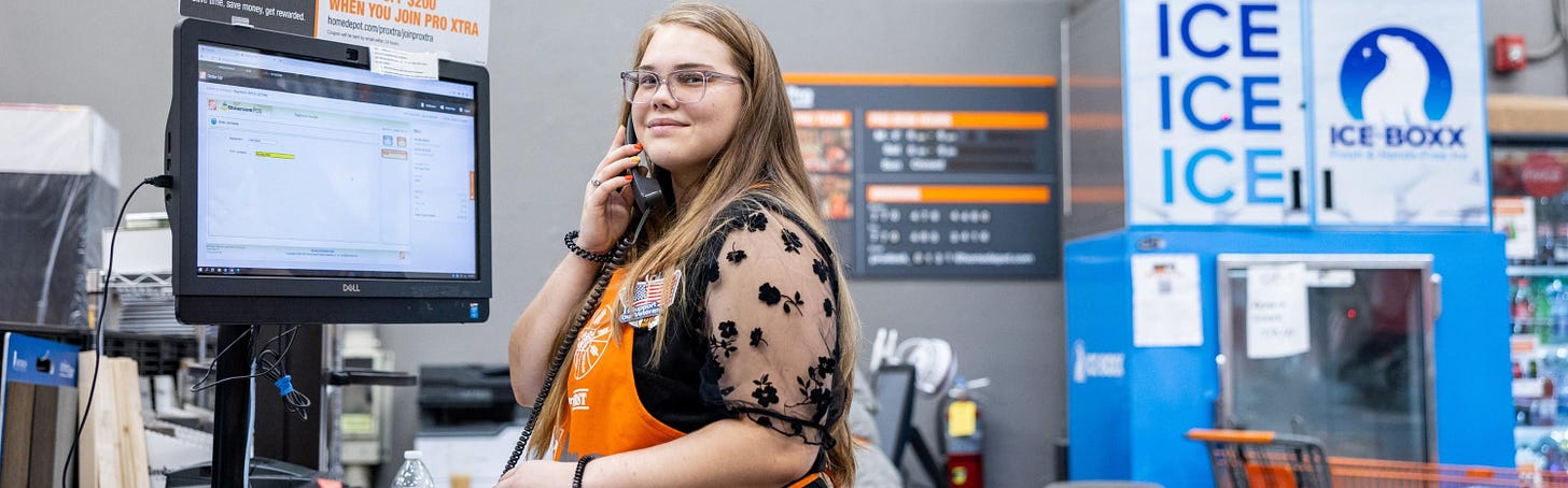 An associate at The Home Depot's Pro desk on the phone.