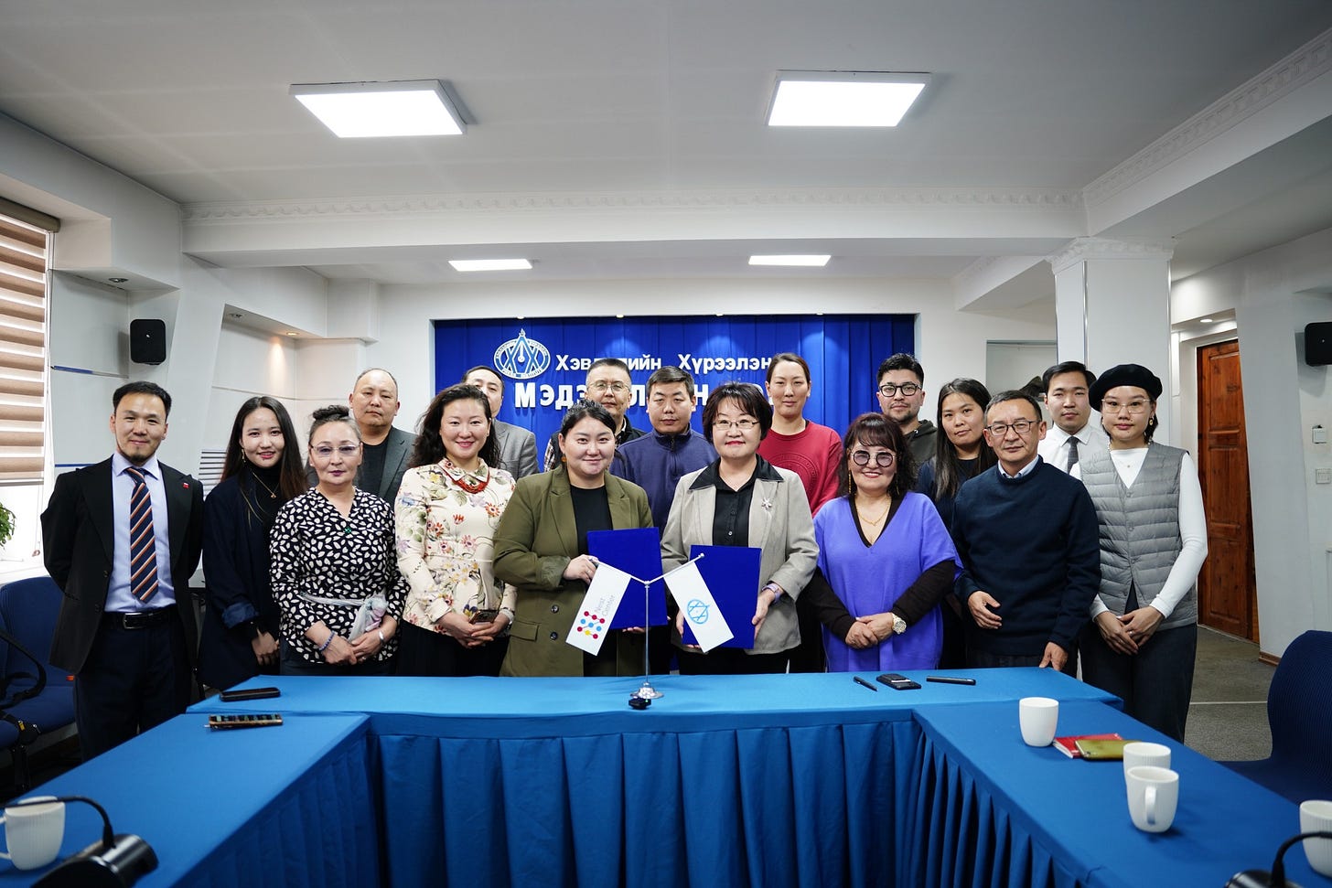 May be an image of 9 people, newsroom and text