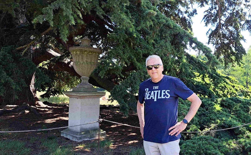 Standing in front of the Yew tree where The Beatles filmed Rain