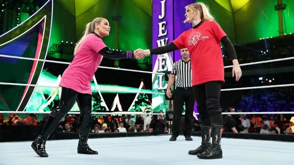 Natalya wrestles Lacey Evans in Riyadh wearing full-coverage gear, with the audience visible in the background.