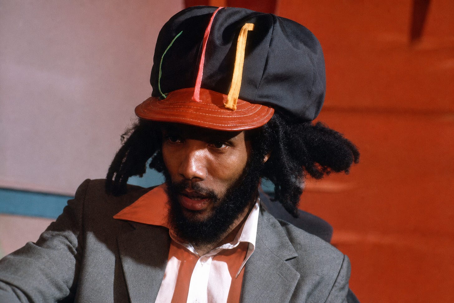 A striking portrait captures the presence of a reggae-era figure, where style, identity, and expression converge in a moment of quiet intensity.