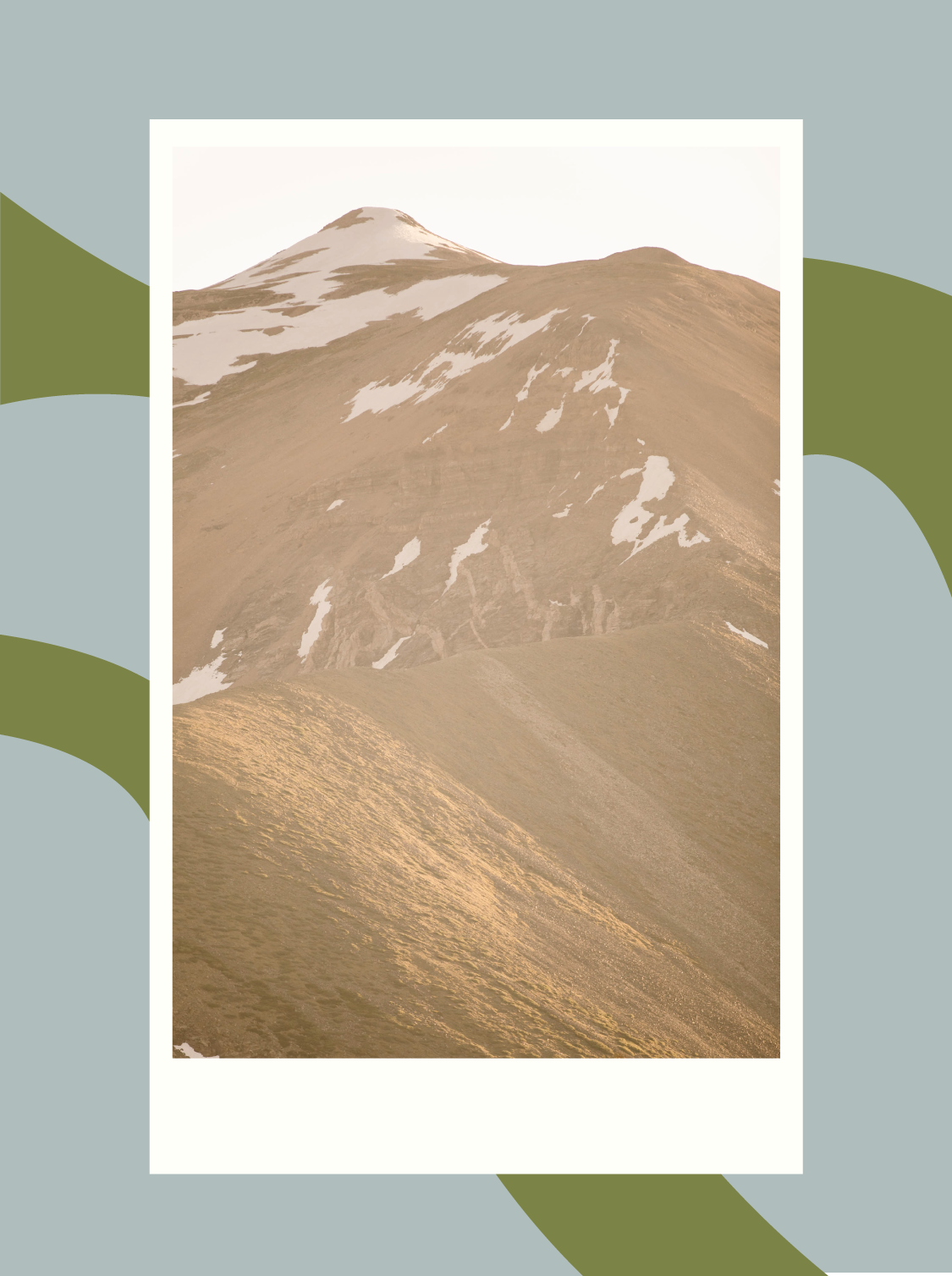 hazy sun on a snow dotted mountain