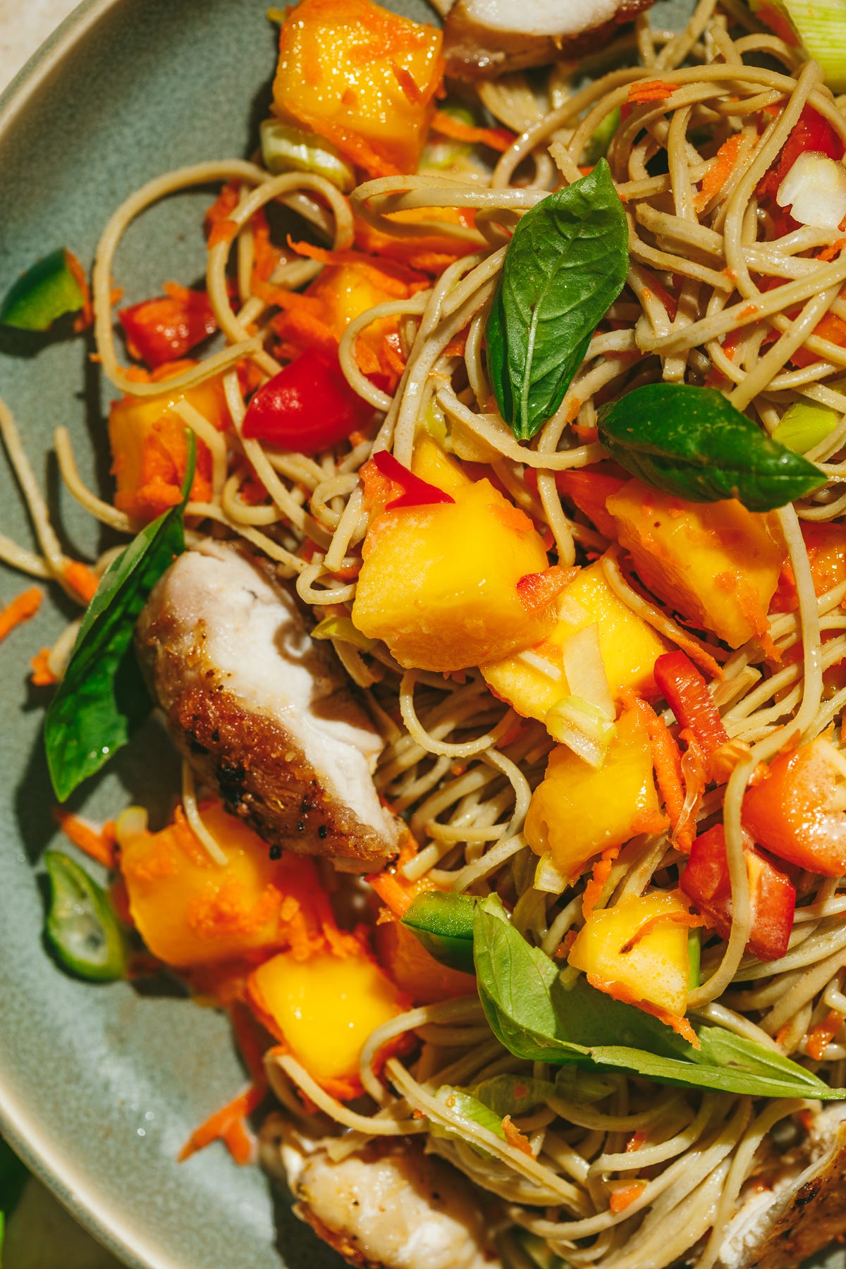 Cold edamame noodle salad on a green plate. 