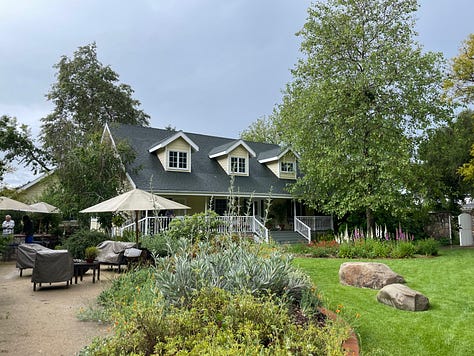 Big yellow country house with flowers and trees, 