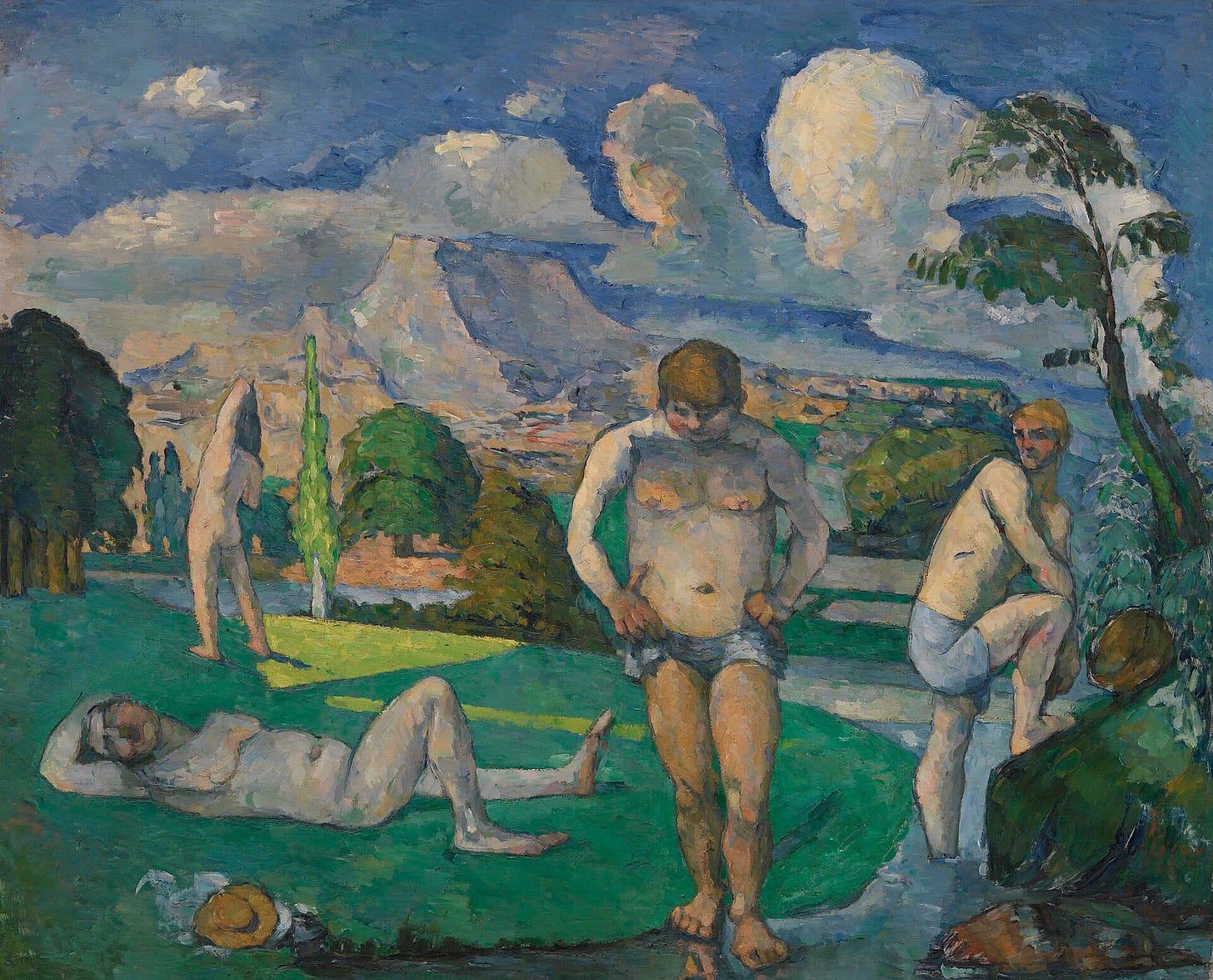 Four naked men sit, lie and stand on a grassy riverbank under a sky of heavy white and blue clouds.