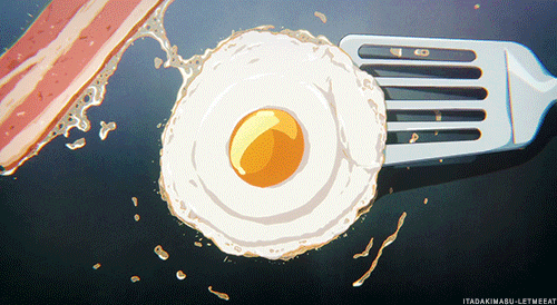This may contain: an egg and bacon are being cooked on the grill