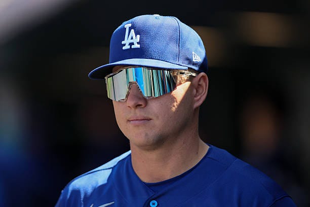 Ryan Ward of the Los Angeles Dodgers wears sunglasses in the dugout in the fifth inning against the Colorado Rockies at Coors Field on April 19, 2026...