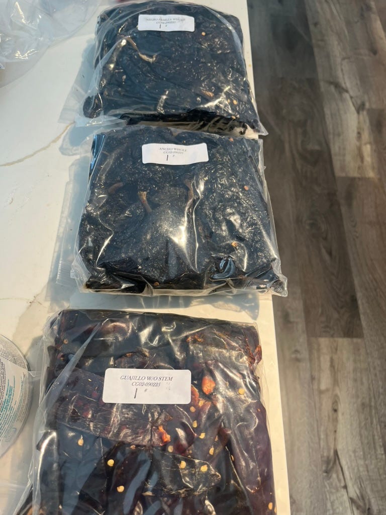 3 bags of dried chili peppers, labeled negro pasilla whole, ancho whole, and guajillo w/o stem