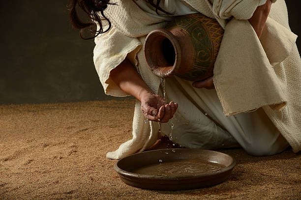 Jesus pouring water Jesus pouring water from a jug washing feet stock pictures, royalty-free photos & images
