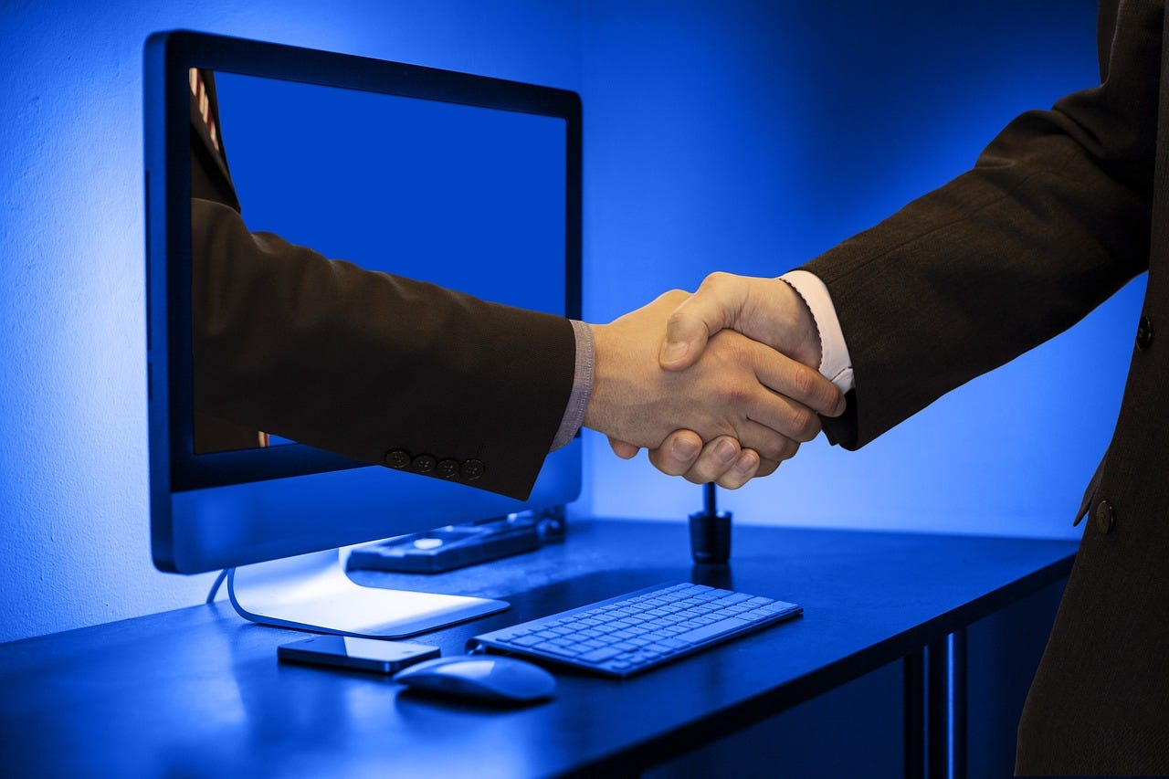 Business trust-building handshake emerging from computer screen | Virtual storytelling connection with skeptical audience | Digital persuasion strategy for brand credibility | Trust-earning business collaboration in blue corporate setting