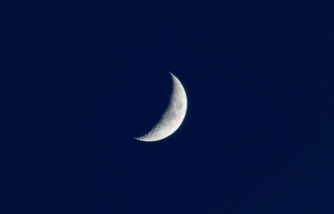 A crescent moon in a dark blue crescent sky A crescent moon in a dark blue crescent sky