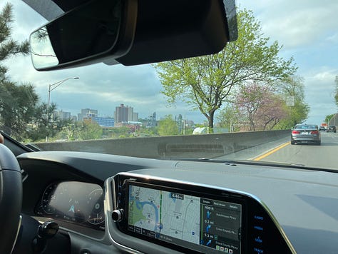 from left to right: first two pics are from the front passenger seat of a car, driving into NYC in the spring time.  You can see new leaves sprouting on the trees.  One picture shows a bit of city skyline off to the side.  The third pic is me, a white female with brown hair, sitting in a lobby wearing a 3M aura.