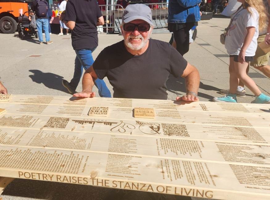 A person sitting at a table with a sign

AI-generated content may be incorrect.