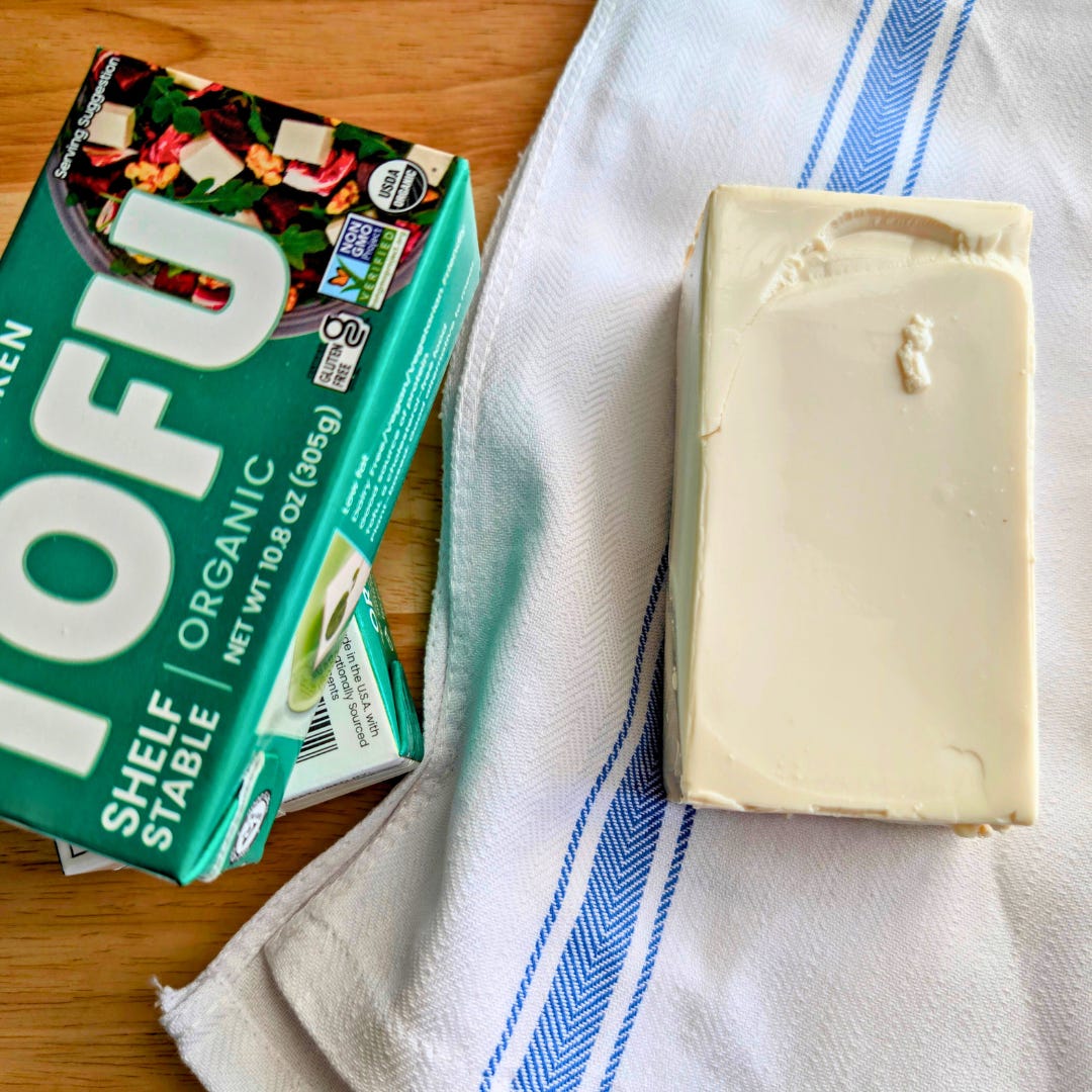 Box of silken tofu on a surface, ready to be turned into hiyayakko.