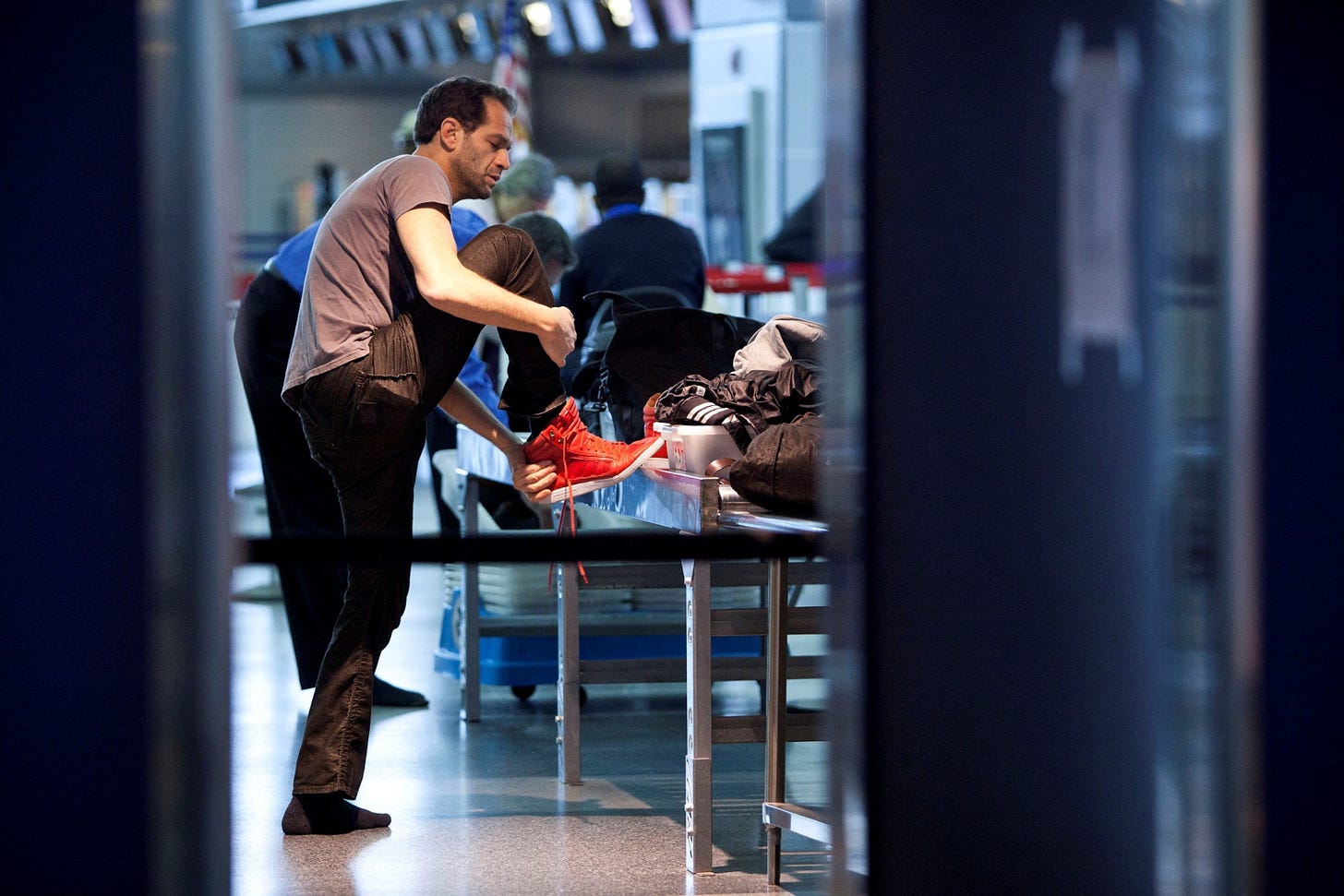 PHOTO: A traveler removes his shoes before going through a security check point at John F. Kennedy Airport in New York PHOTO: A traveler removes his shoes before going through a security check point at John F. Kennedy Airport in New York