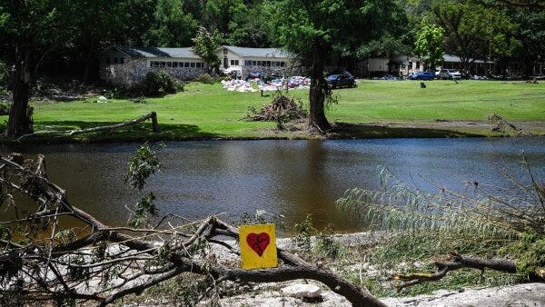 A painted broken heart is seen near Camp Mystic along the Guadalupe River in Hunt, Texas, on July 8 after severe flash flooding over the July 4 holiday weekend. 
