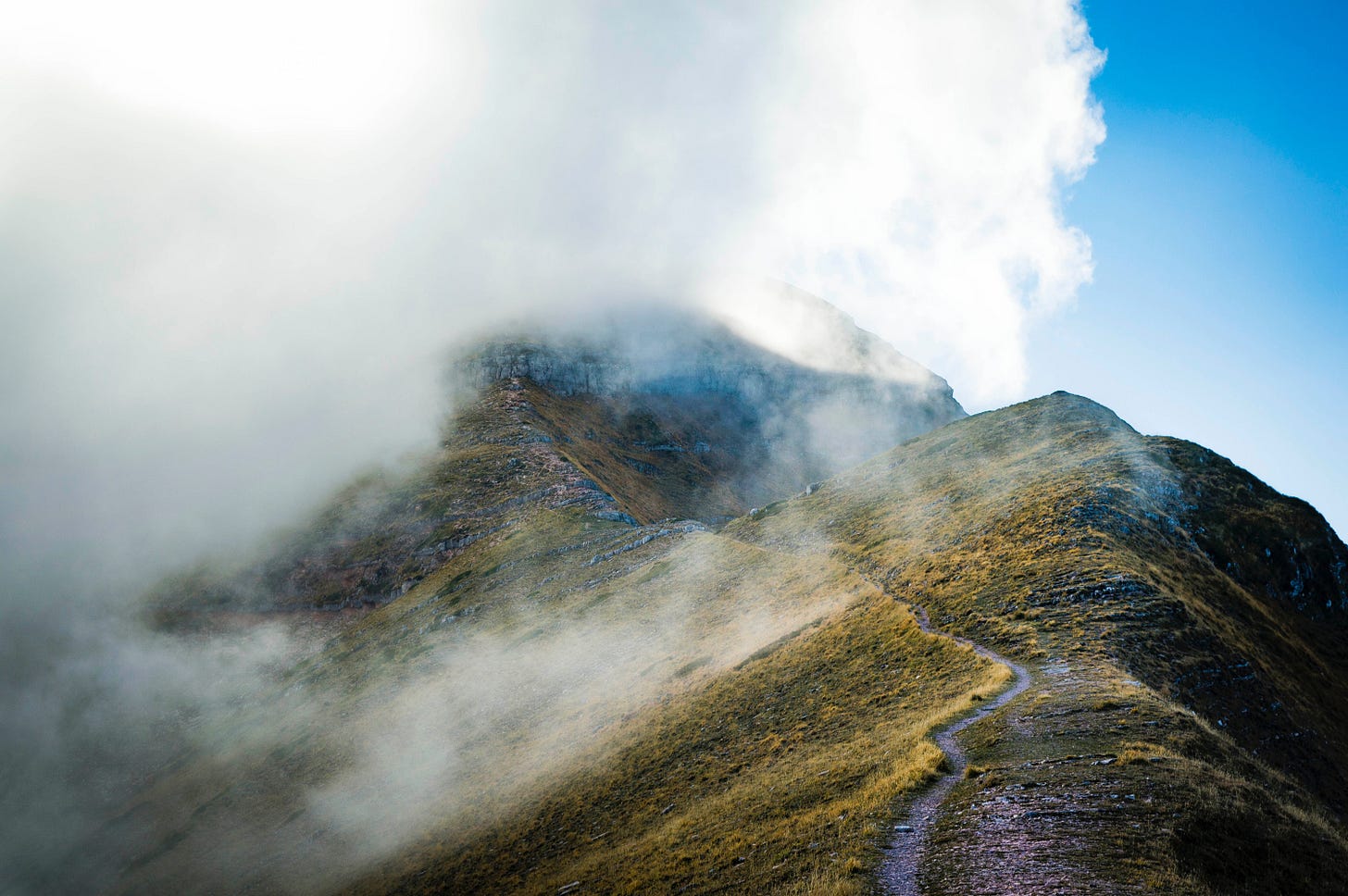 Cloud covered mountain top with a path leading up to it. Cloud covered mountain top with a path leading up to it.