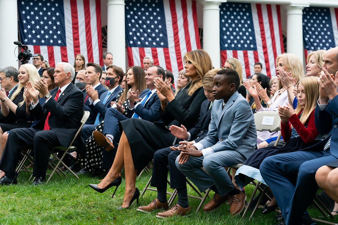MAGA staffers sitting together, awaiting Covid