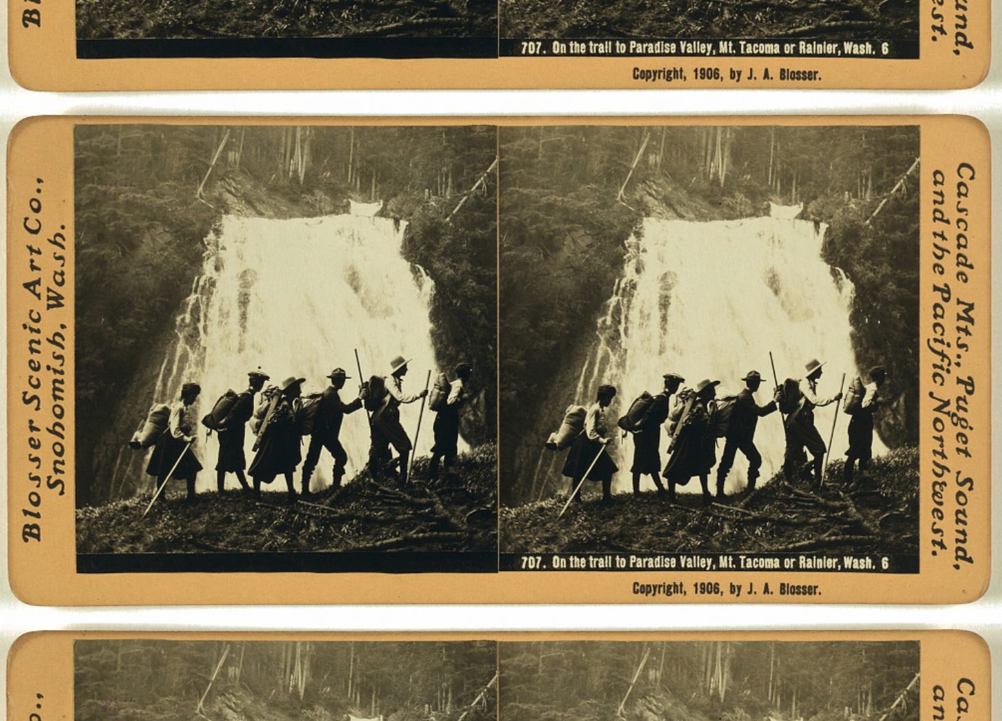 The sepia-toned image from 1906 shows a group of 6 hikers with trekking poles and period clothing hiking in front of a waterfall somewhere in Washington.