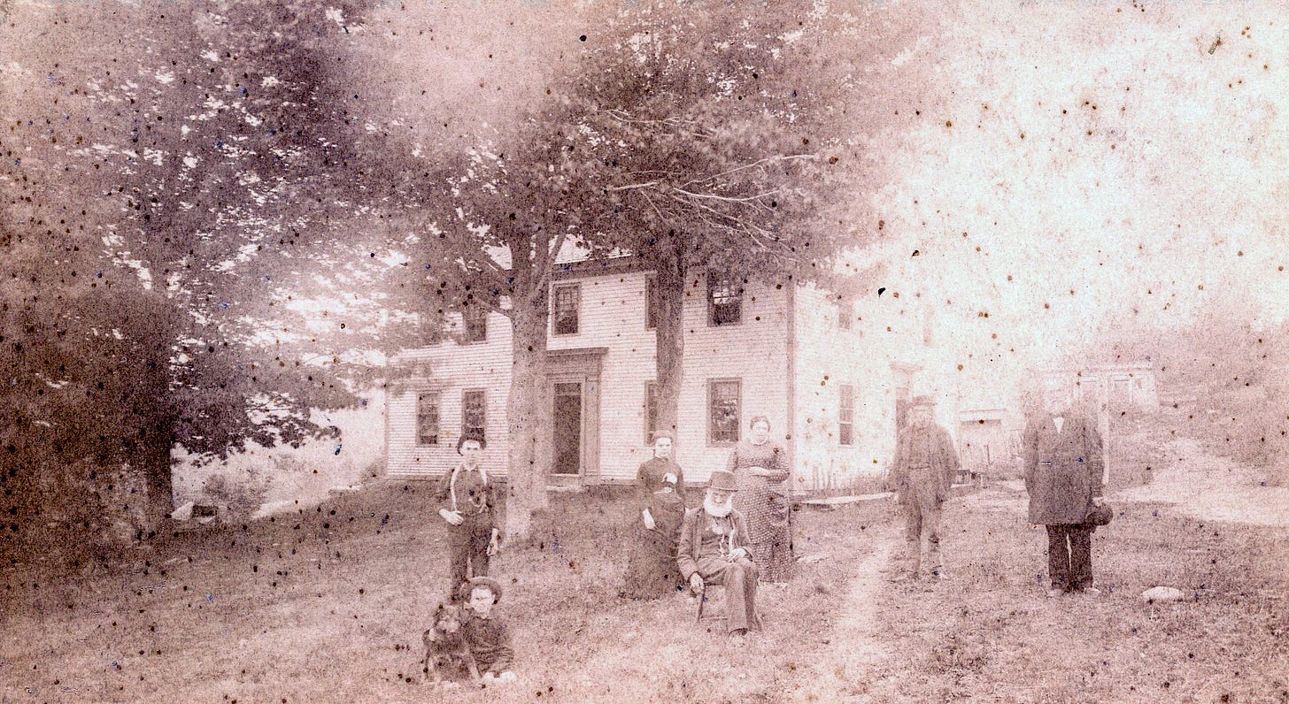 7 people and one dog in front of house