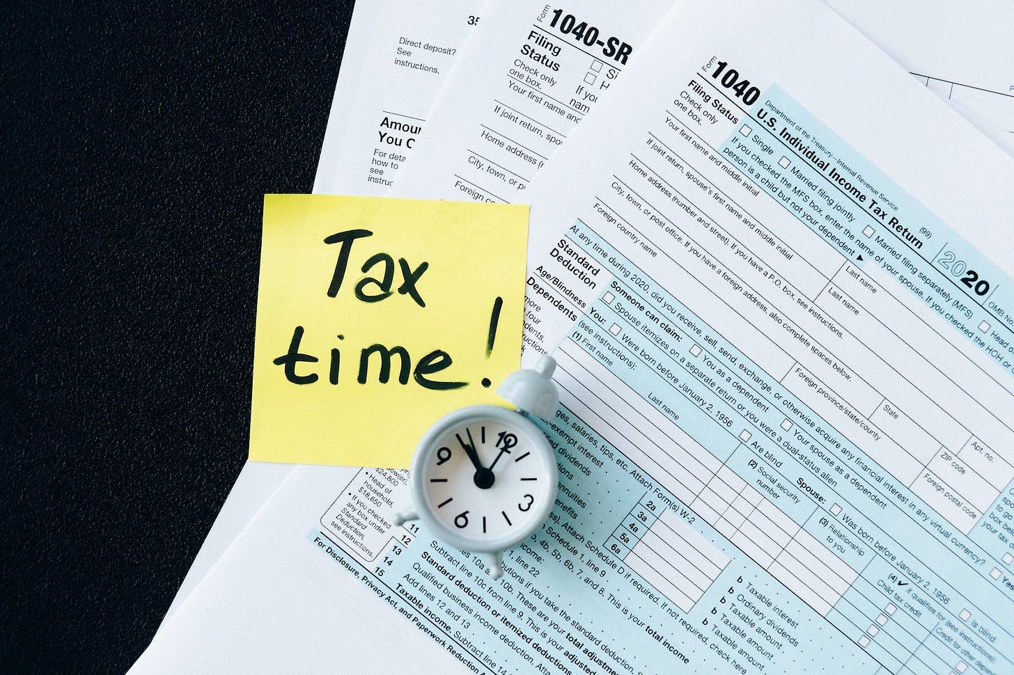 tax documents on black table tax documents on black table