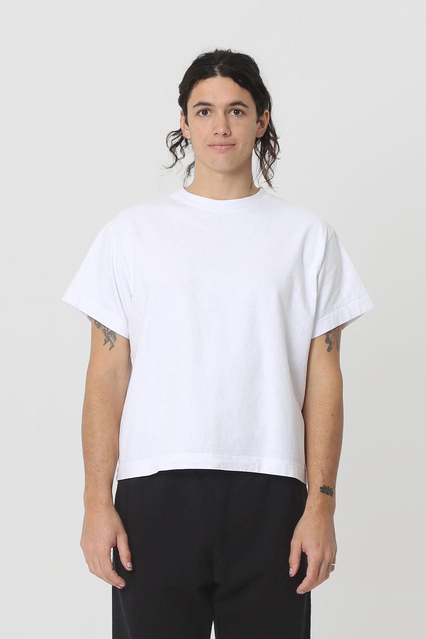 6' person in a White Heavyweight Boxier Trash Tee, size M. Hem ends at their middle hip.