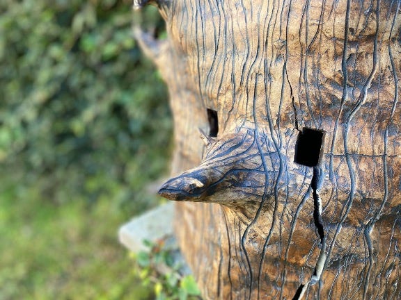 Ceramic trunk mask with rectangular eye holes and branch nose. 