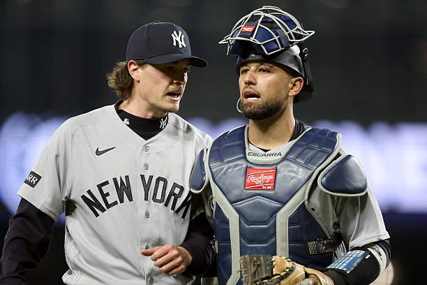 Max Fried and J.C. Escarra of the New York Yankees react during the sixth inning against the Seattle Mariners at T-Mobile Park on March 31, 2026 in...