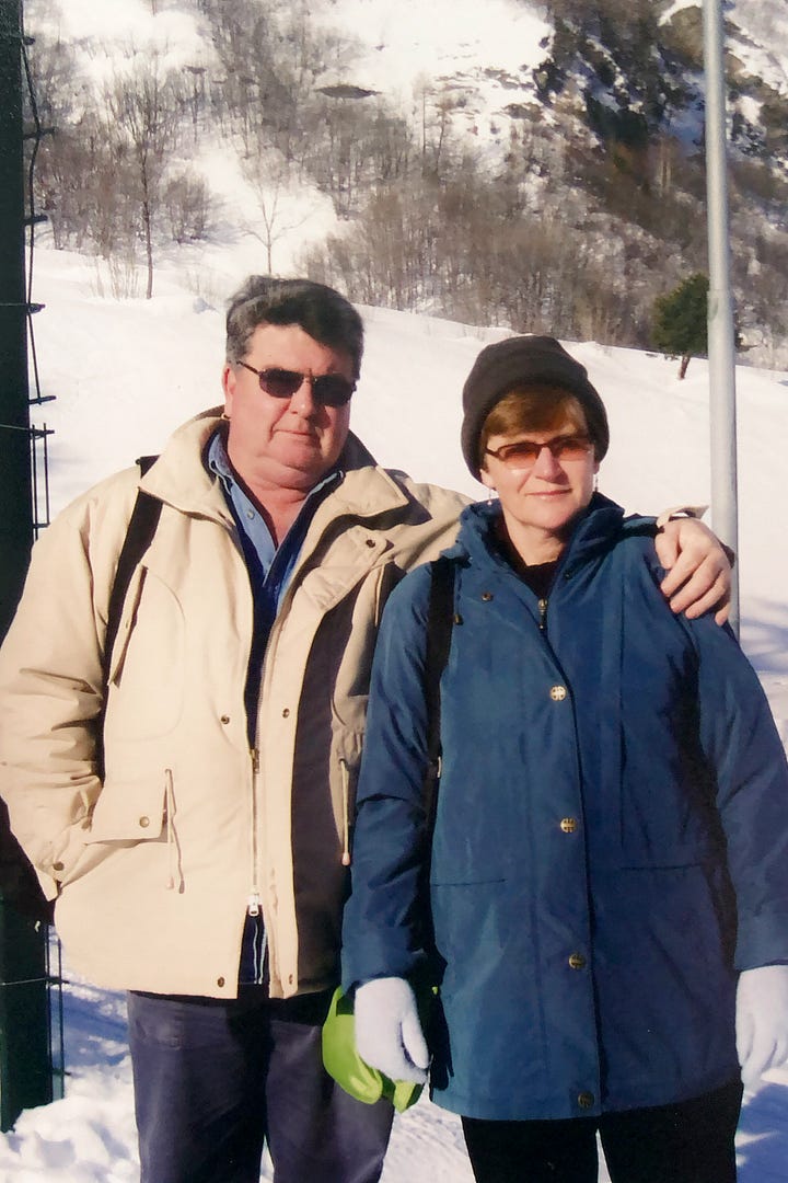 A man and woman in the snow + two teenagers