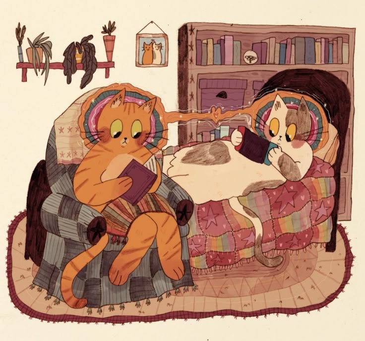 This may contain: two cats are sitting on a couch and one cat is laying next to the other This may contain: two cats are sitting on a couch and one cat is laying next to the other