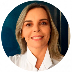 Jaqueline Scholz é uma mulher de cabelos loiros e longos. Ela usa uma camisa branca Jaqueline Scholz é uma mulher de cabelos loiros e longos. Ela usa uma camisa branca