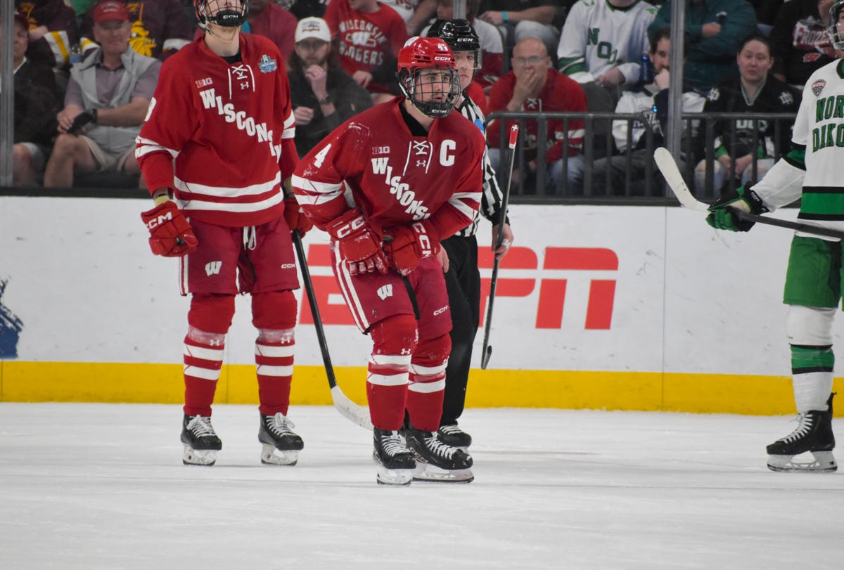 Ben Dexheimer grabs his right leg while skating off the ice